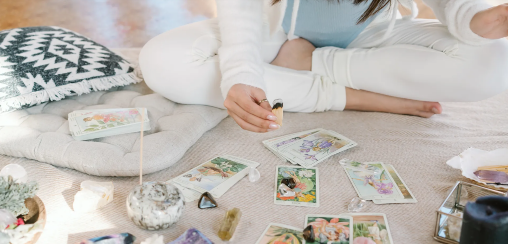 Tarot reading setup with cards and crystals on the floor