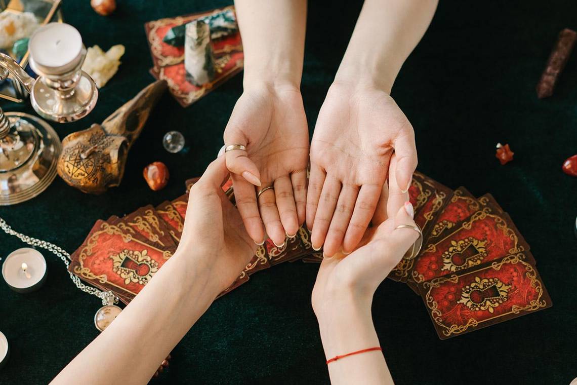 Hands open during a tarot and palm reading session